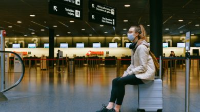 woman sitting on luggage
