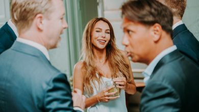 cheerful woman and men on celebration in restaurant